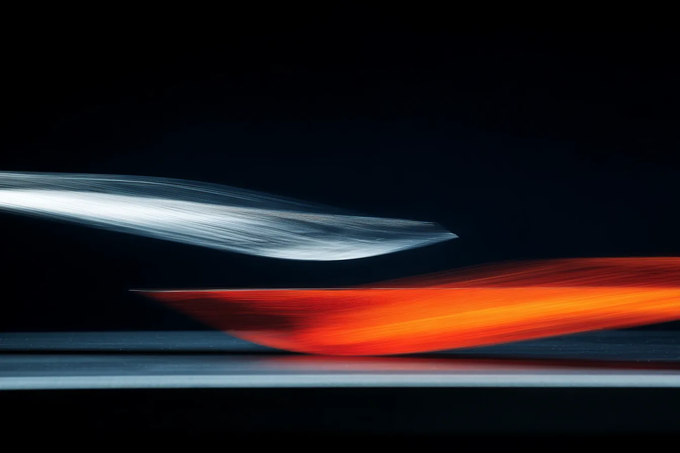 Two identical glass rods suspended in dark space, one poised still, one vibrating with blur at the tip, under a single lateral raking light