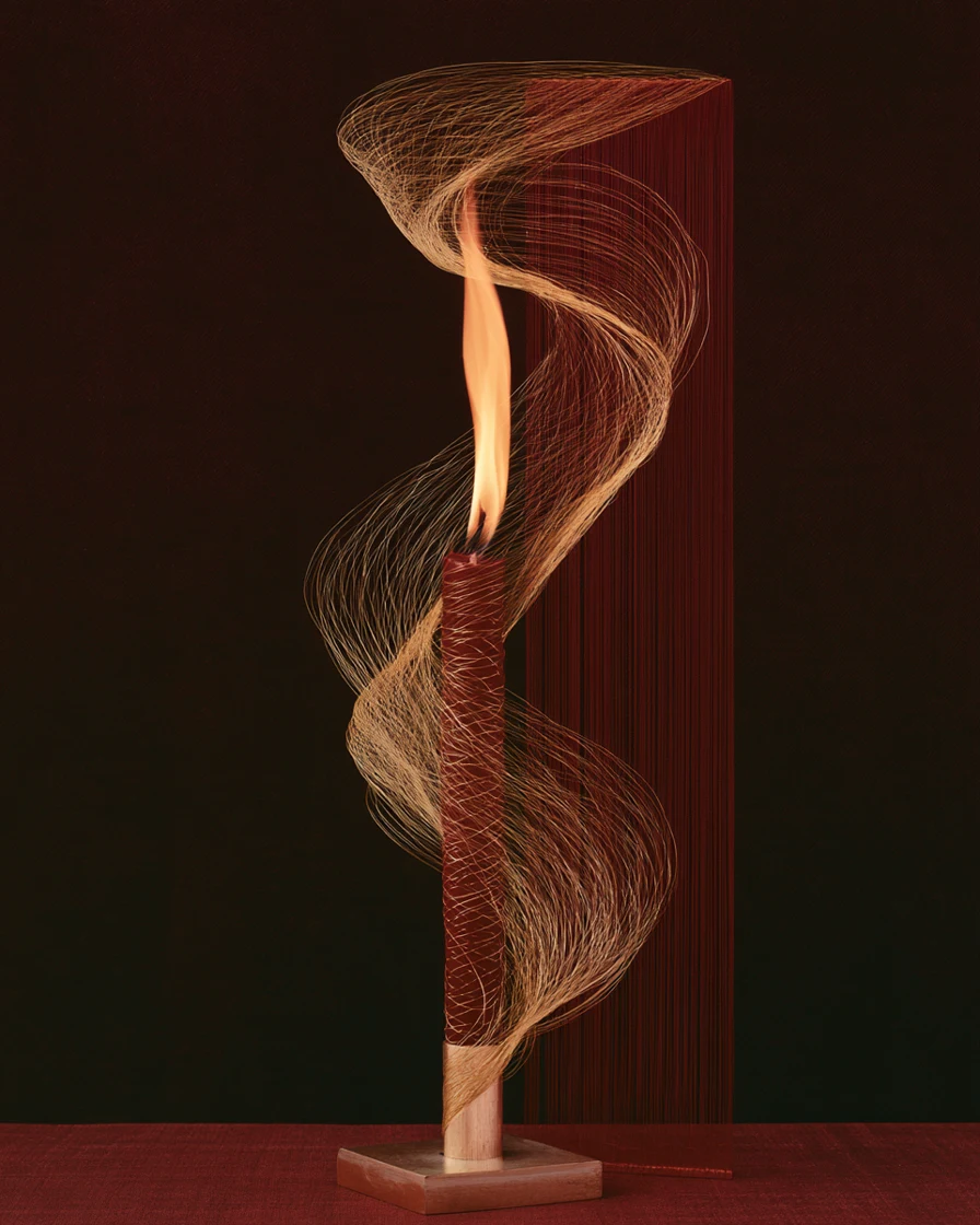 Candle flame wrapped in swirling gold threads against deep red